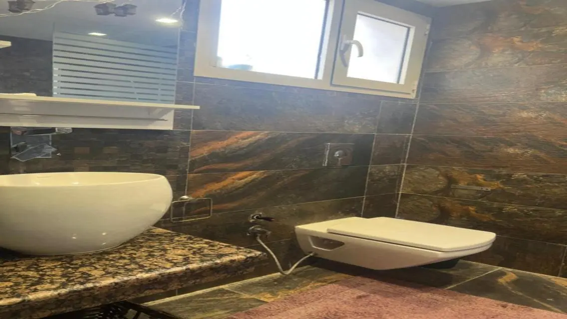 Luxury Apartment with Private Garden and Shared Pool in Prime Location